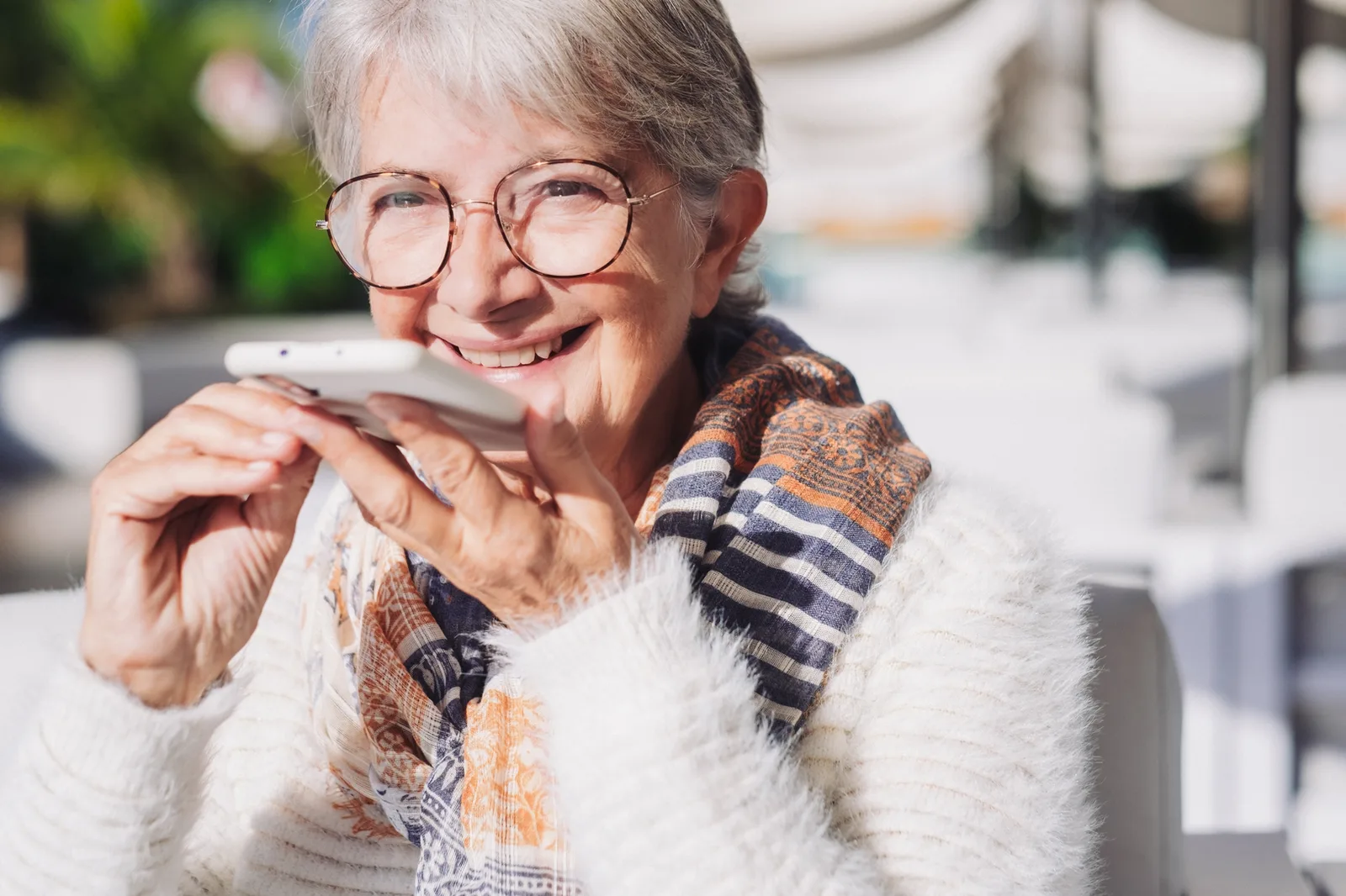 Smiling senior woman talking on the phone outdoors